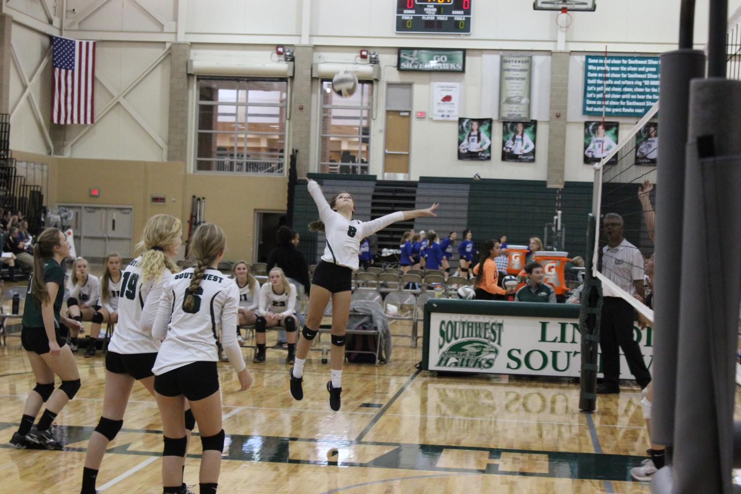 Freshman Avery Tomlinson jumps to spike the ball in the match against North Star. The Hawks went on to lose the championship game to Southeast.
