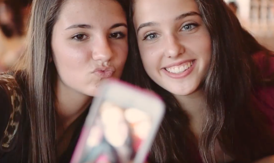 These two students taking a selfie is an image from one of PBiS's behavior presentations.