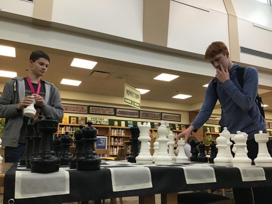 James Moeller and Hawkin Sibley play chess in the Media Center after the layout has changed. The two often play a speed round after school.