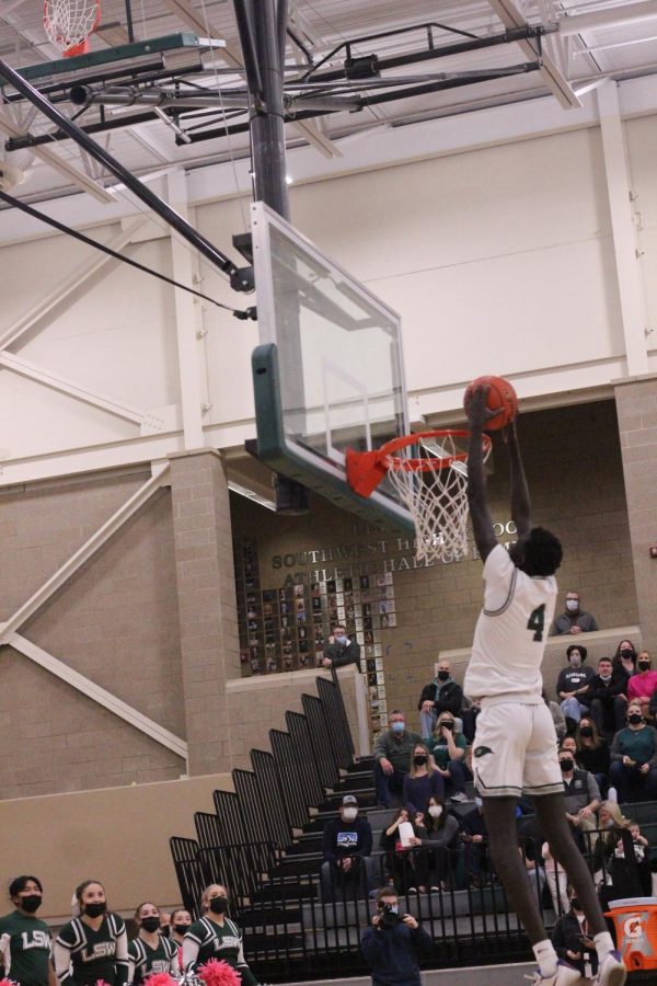 Sophomore Bhan Buom dunking against Lincoln North Star.