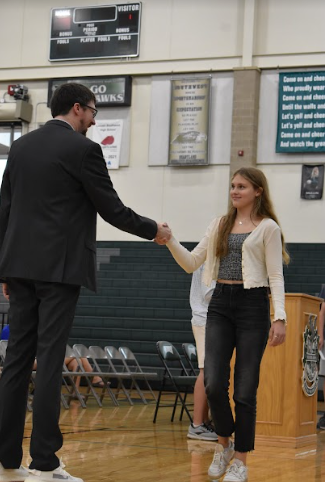 Senior Addison Stelzer shakes hands with Mr. Matzen. The Honors Convocation was held on Wednesday, Sept. 14 in the Main Gym. 