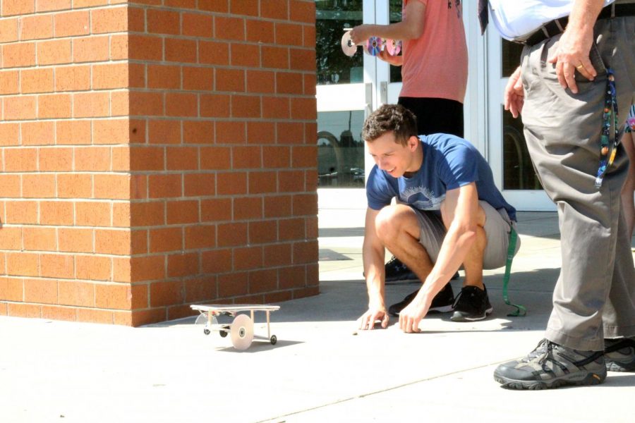 Senior Brady Gebbie tests his Mars Rover in front of the school during astronomy.