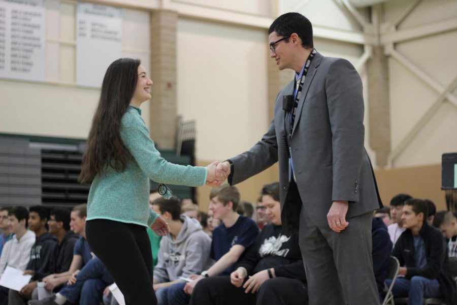Sophomore Ava Spinar shakes Principal Michael Gillottis hand during Honors Convocation on Thursday, Feb. 21.