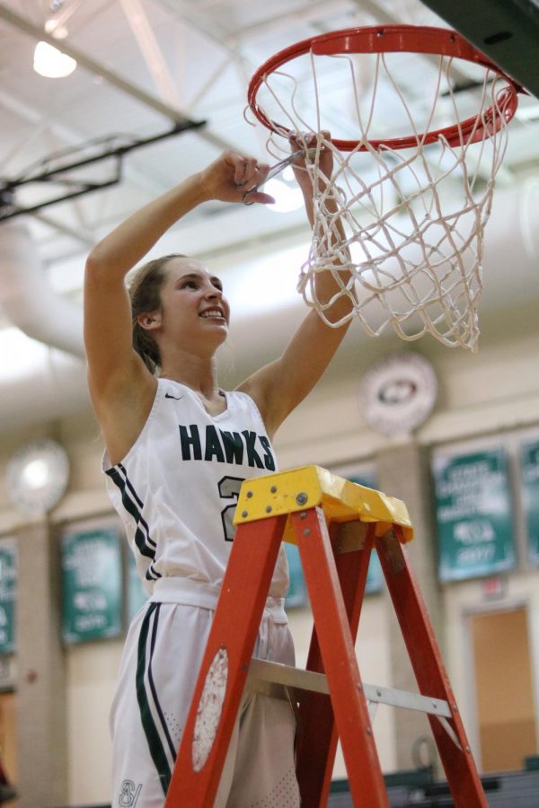 Senior guard Emma Kauf cuts down the net after Southwests 45-20 victory over Southeast last Friday. The Hawks will play Omaha Westside on Friday at Pinnacle Bank Arena. Tip-off will be at 3:45 p.m.