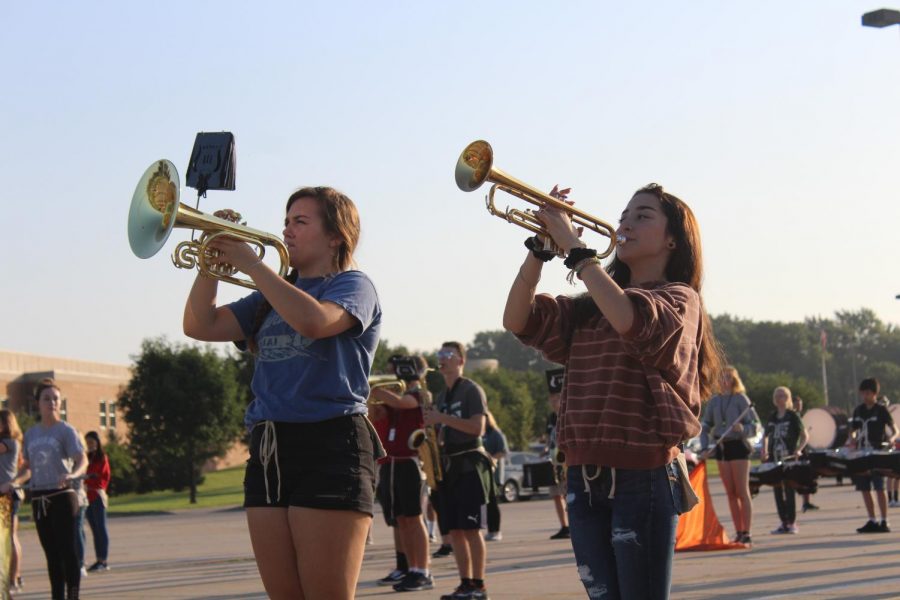 
Junior Tenley Katt and sophomore Shayla Cordova set their drill during zero hour marching band practice. The show this year honors the 50th anniversary of the Apollo 11 mission. 
