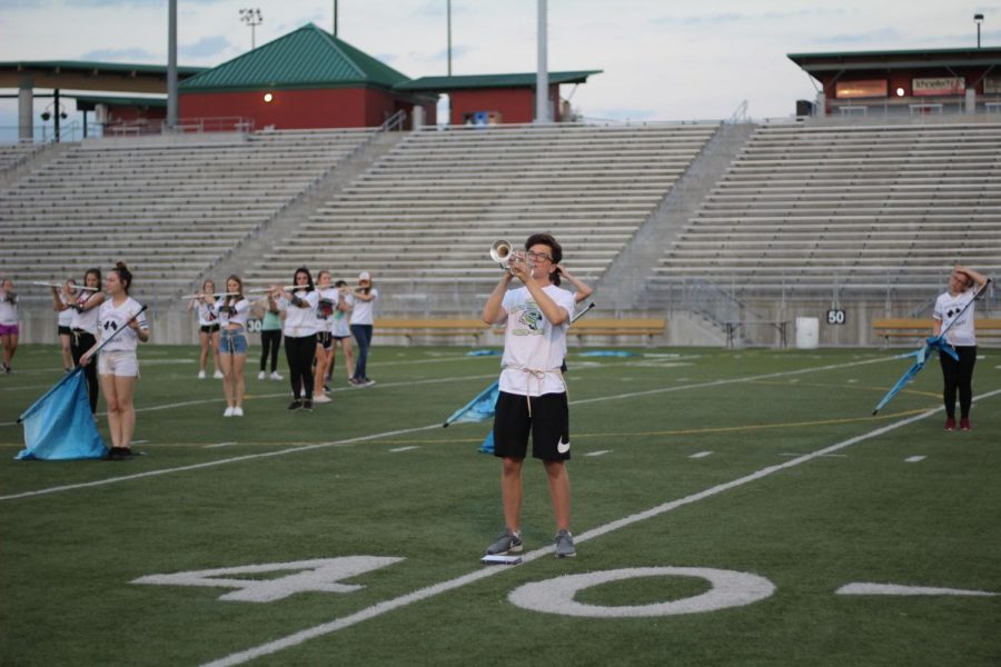 Junior Max Schirmer plays his solo in the second movement of the 2019-20 marching band show. The band competes at Harvest of Harmony this Saturday, Oct. 5, 2019. 