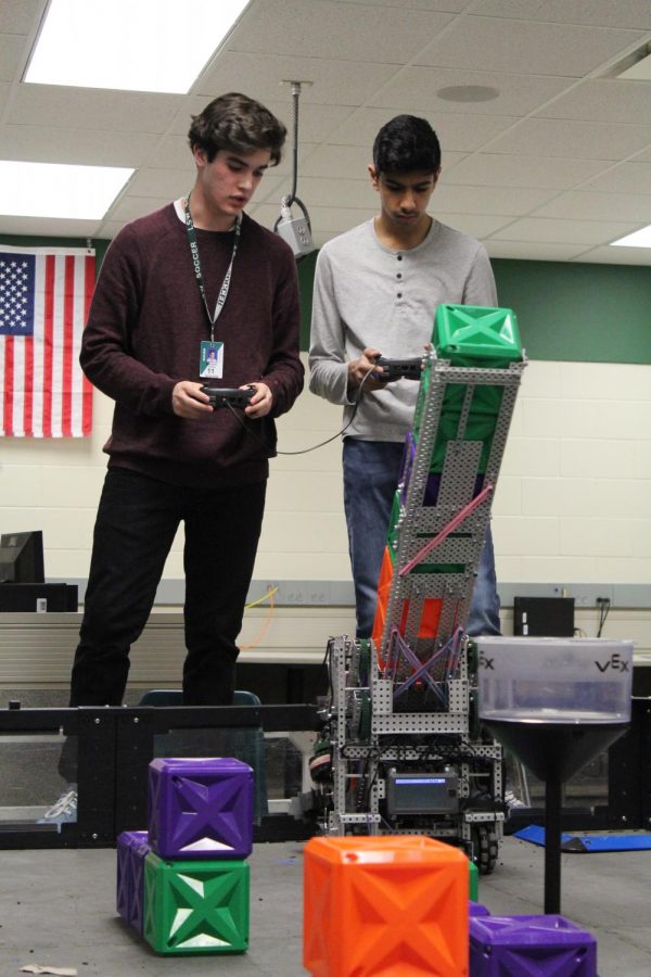 Kareem Keshk and Yasir Almotawa practice driving the robot. The robotics team won their tournament on Jan. 25.