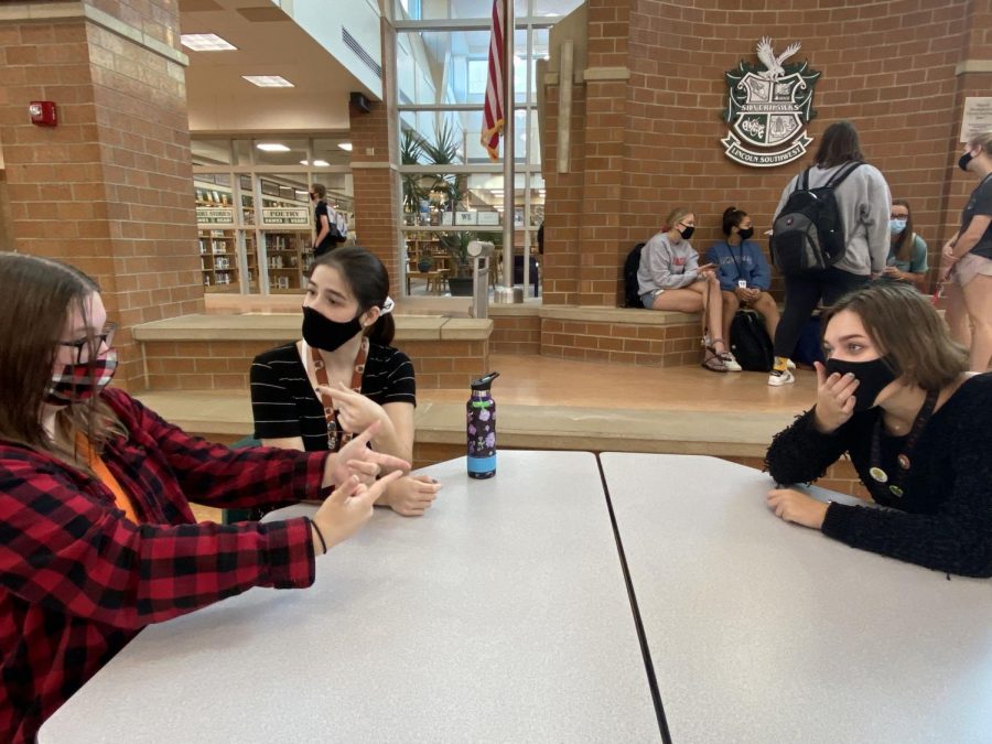 Seniors Jessica Hammers, Kailey Keith, and Rachel Hlavac interact with each other before class starts. Students are strongly encouraged to social distance when possible, and to use hand sanitizer as often as possible. 
