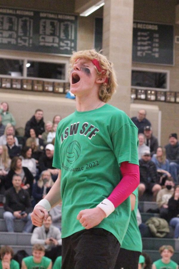 Freshman Jackson Carpenter celebrates a point scored during Make-A-Wish charity volleyball game.