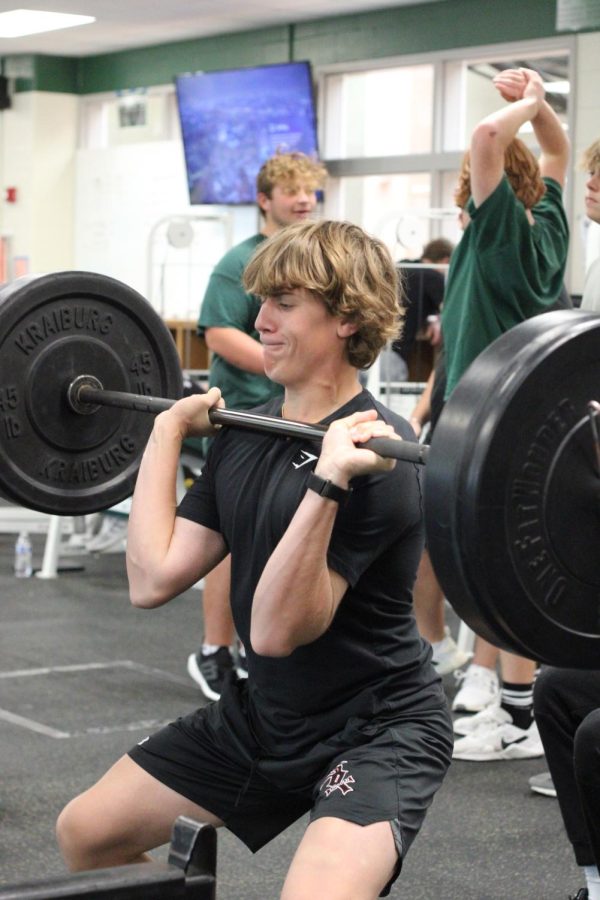 Student does a front squat in weight training on Oct. 4, 2022. Weight training is available as a P.E. credit every term.