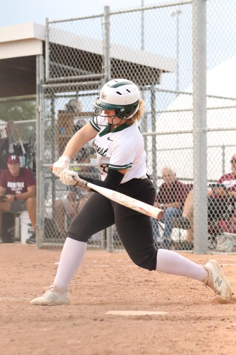 Junior Emma Dostal bats the ball against Norfolk in the 2022-2023 season. The Hawks swept the Panthers in a doubleheader on Aug. 17, 2023, which was the first time in four years. 