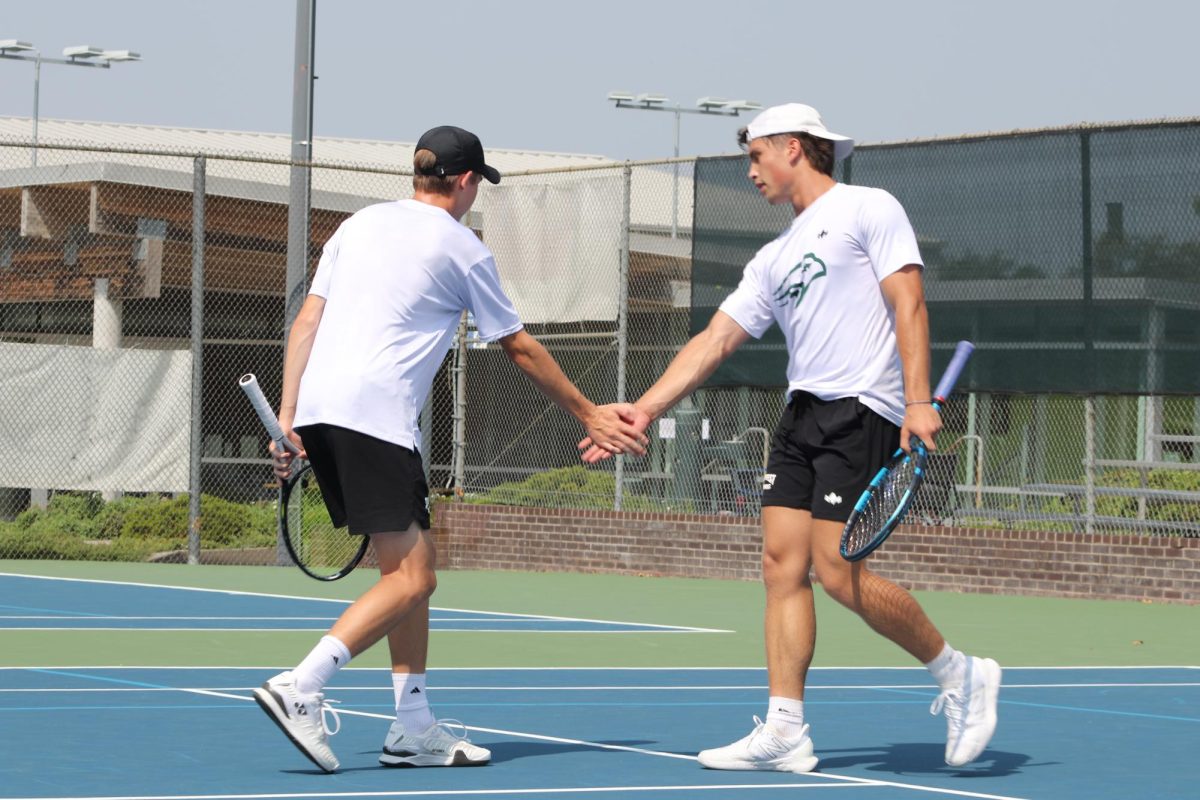 Doubles partners, junior Barrett Warner (left) and senior Jack Felt (right) celebrate a successful point. The pair has won 12 of their 14 matches. 