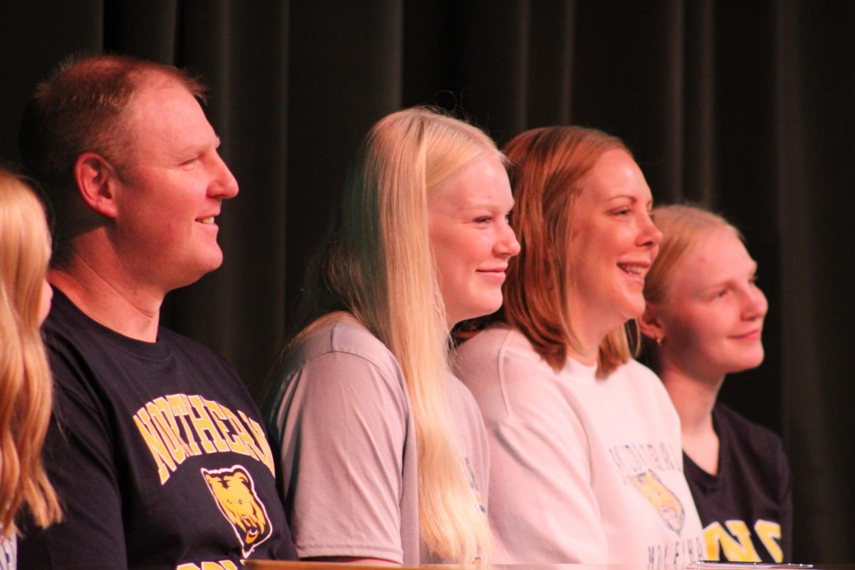 Senior+Maddie+Rink+and+her+family+on+stage+as+Rink+signs+her+letter+of+intent.+11+Southwest+seniors+signed+letters+of+intent+to+play+collegiate+sports+on+Wednesday%2C+Nov.+8.