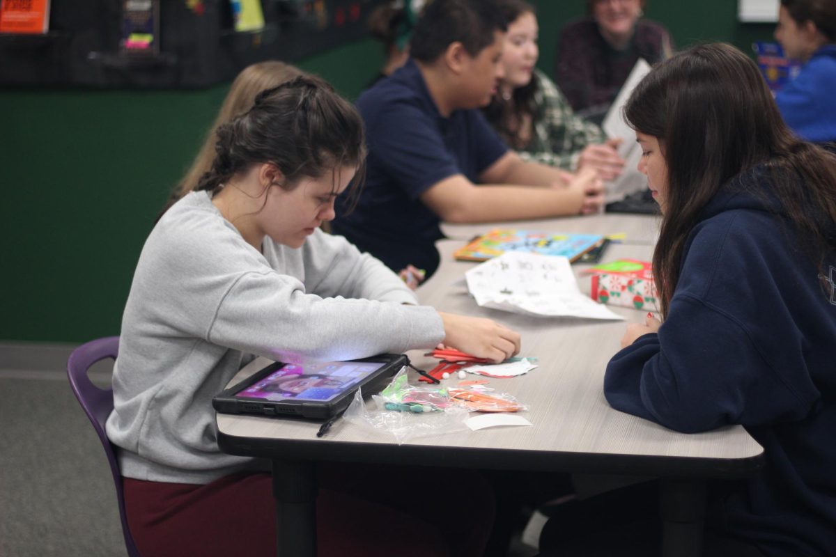 Students work together to create Christmas crafts at Unified Book Club. The next meeting is Dec. 13.