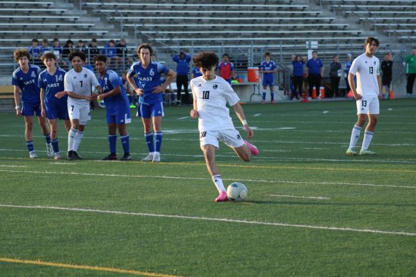 Senior Mabast Alawadi kicking a penalty kick against Lincoln East. The Hawks play Lincoln Southeast on Wednesday, April 3, at 5 p.m. at Seacrest Field. 