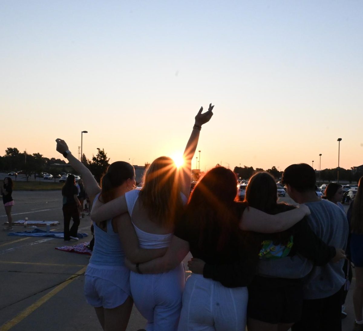 Seniors Melanie Wiggins, Katie Timmer, and Charlie Rader (left to right) pose behind the sunrise towards the end of Senior Sunrise. At 6 a.m. on Friday, Aug. 16, Southwest Student Council (StuCo) hosted Senior Sunrise in parking lot C by the tennis courts.