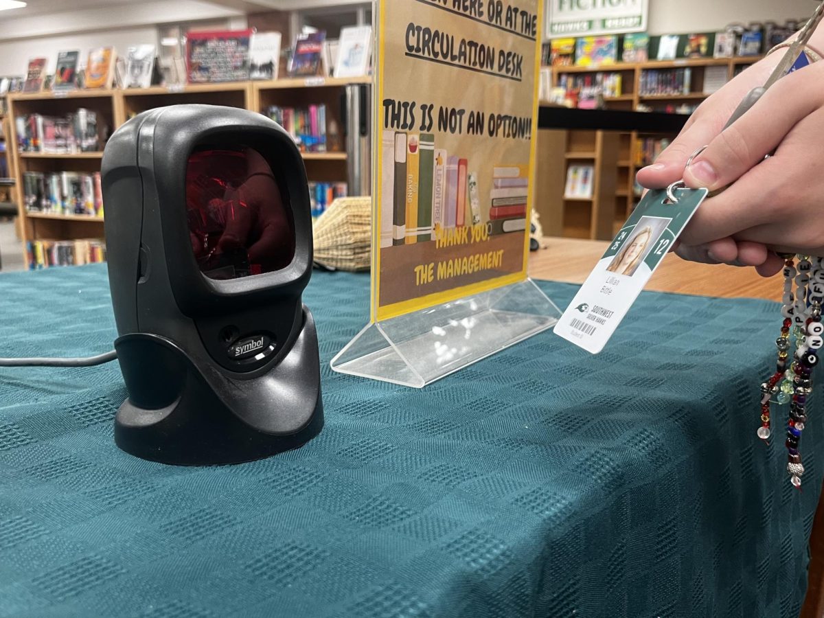 A student scanning their ID to get into the library. IDs are used to get lunch, get into the school, check out books and more.