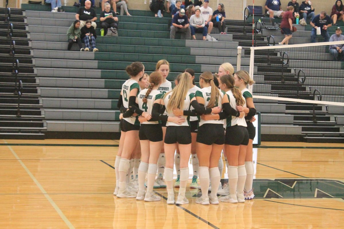 The JV Volleyball team in a huddle before their game. This was before they faced off against North Star and ended up winning.