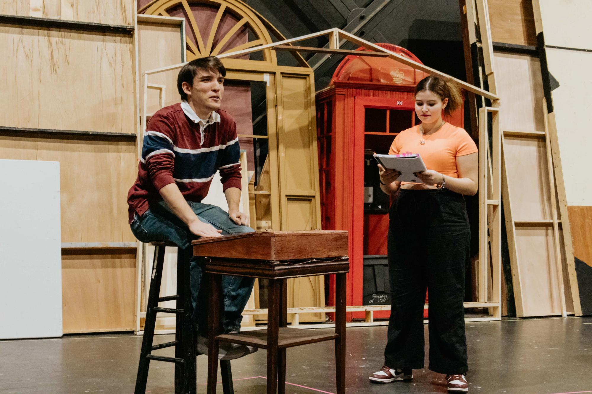 Senior Matthew Killham speaks as Ebenezer Scrooge along with junior Marie Borst during a rehearsal. Tickets for "A Christmas Carol" went on sale Monday, Nov 4.