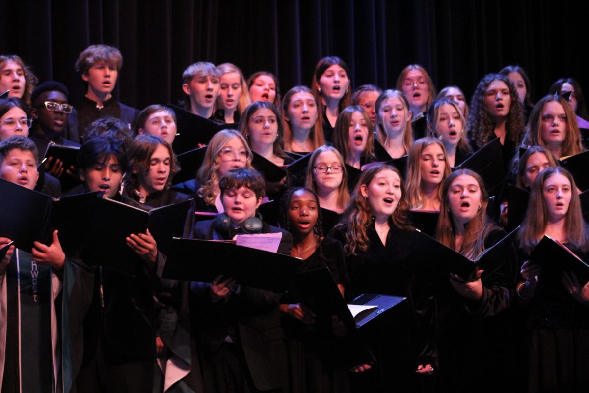 Southwest's choir ensembles perform a piece in the auditorium. Choir, band and orchestra will perform at their annual winter concert on Monday, Dec. 9.