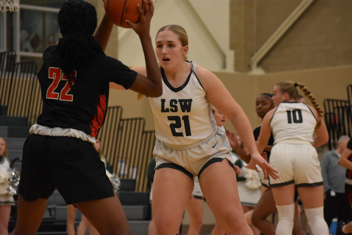 A member of the varsity girls basketball team playing against Lincoln High. At this particular game LSW won 53-37.