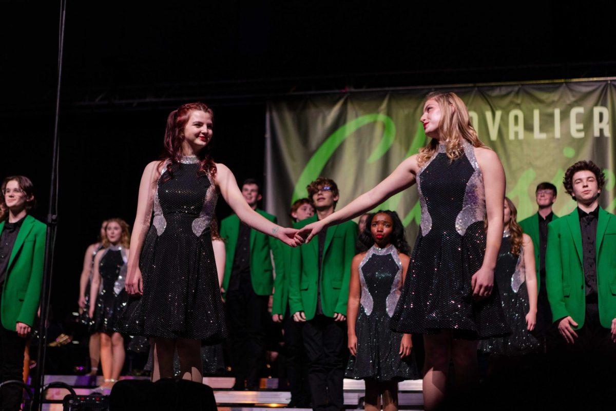 (Left to right) Juniors Koda Walker and Brielle Schoenleber are holding hands during the ballad at the beginning of the Ambience show at Sioux Falls Jefferson High School on Saturday, Jan. 11. Ambience won the prep division.