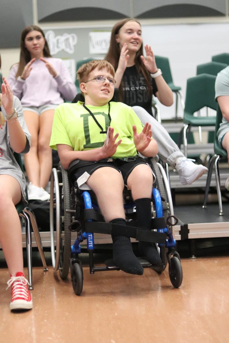 Junior Dathin Cooper clapping to the rhythm in Unified Choir. The Unified Choir concert will take place on Friday, Oct. 3, 2025.