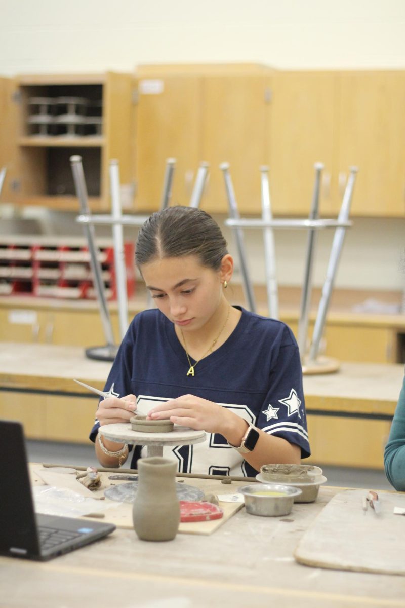 Sophomore Amina Isokova working on a project for Pottery class. The class was making ten inch coil pots.