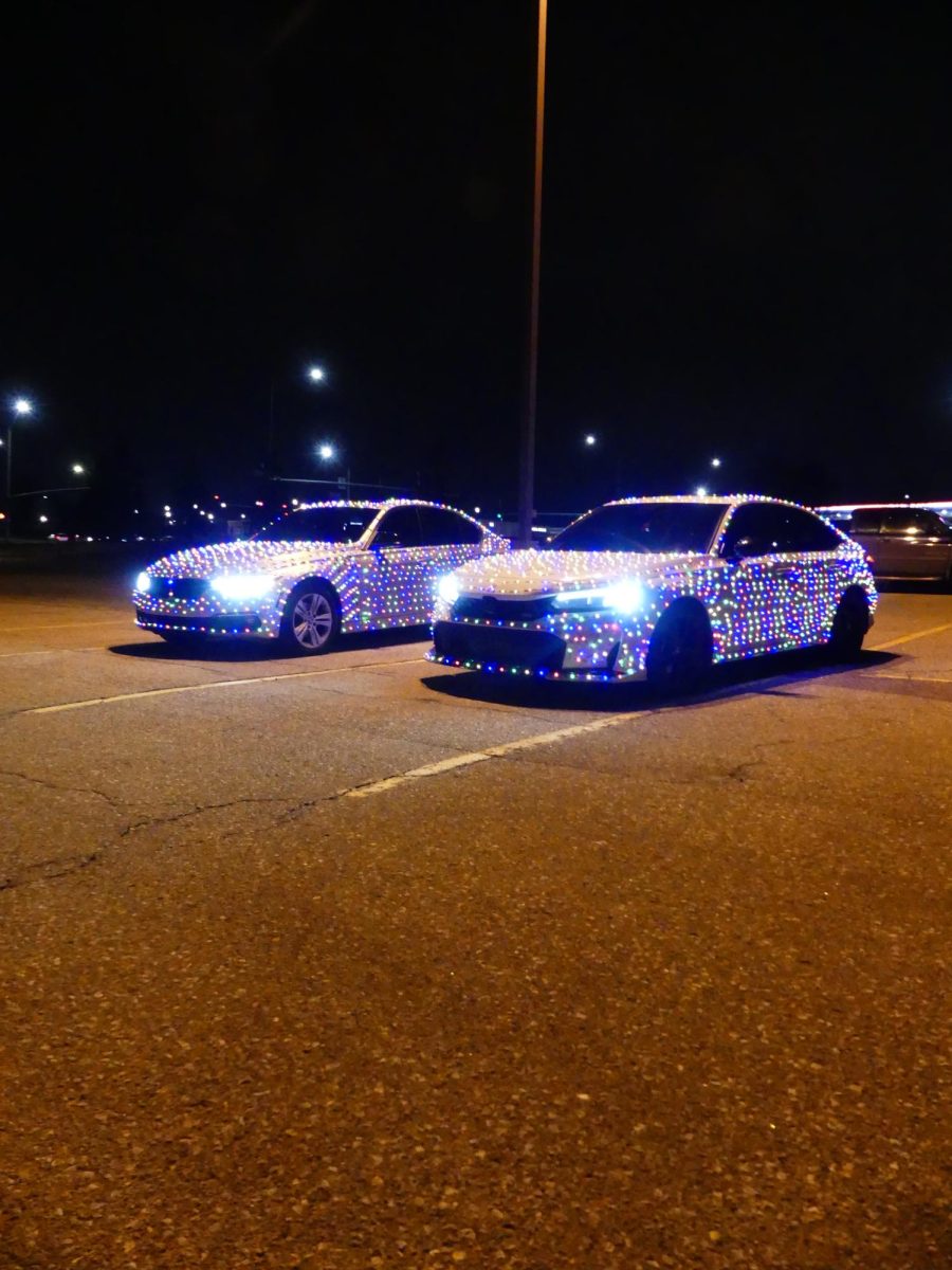 Senior Carter Sanburn and Senior Jayden Beckman vehicles covered in Christmas lights in the LSW parking lot.