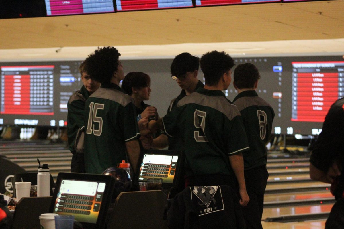 Boys bowling team in a huddle before their match. They placed second overall in the tournament